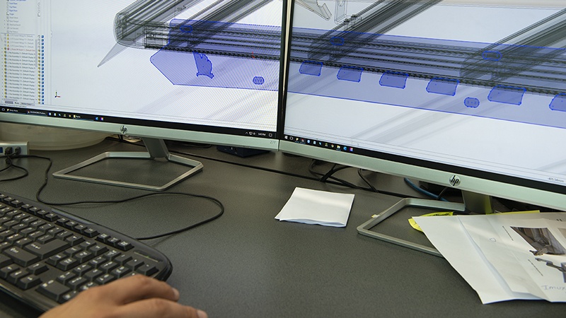 Computer operator with Wedgetail CAD design showing on the computer screen.